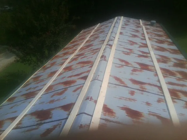 Rusted metal roof panels with new wood purlins before replacement — Storm Damage Roof Repair in South Butler by Roofing Brothers